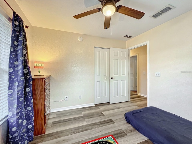 12181 SE 87th Ct, Belleview, FL 34420 - bedroom with wood finished floors, a ceiling fan, a closet, and a textured wall