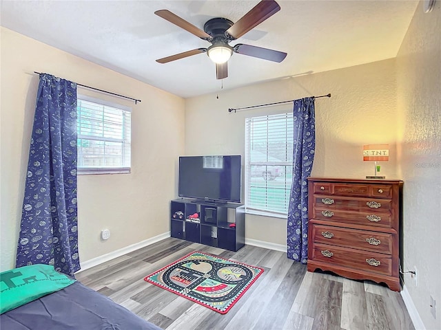 12181 SE 87th Ct, Belleview, FL 34420 - bedroom featuring wood finished floors, multiple windows, and a ceiling fan