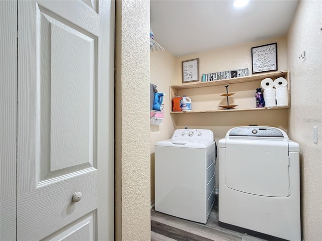 12181 SE 87th Ct, Belleview, FL 34420 - laundry room with wood finished floors and washer and clothes dryer