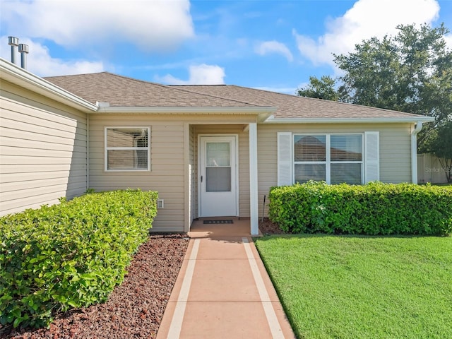 2369 Five Forks Trl, The Villages, FL 32162 - doorway to property with a lawn and roof with shingles