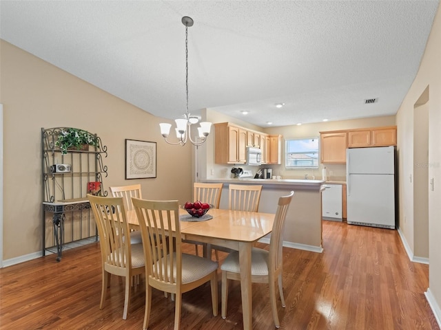 2369 Five Forks Trl, The Villages, FL 32162 - dining area featuring light wood finished floors and a chandelier