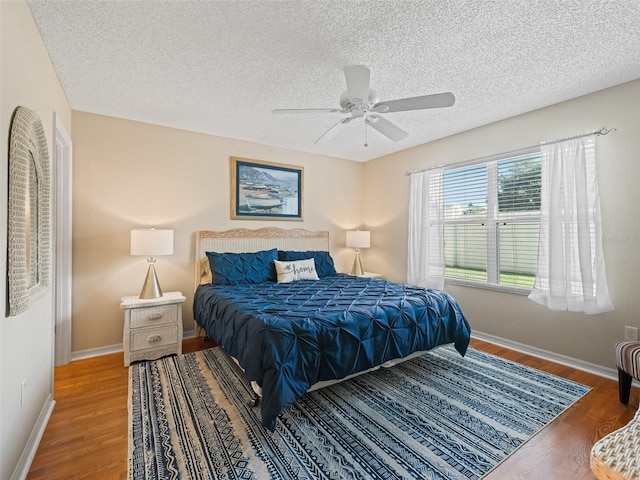 2369 Five Forks Trl, The Villages, FL 32162 - bedroom with wood finished floors, a textured ceiling, and ceiling fan