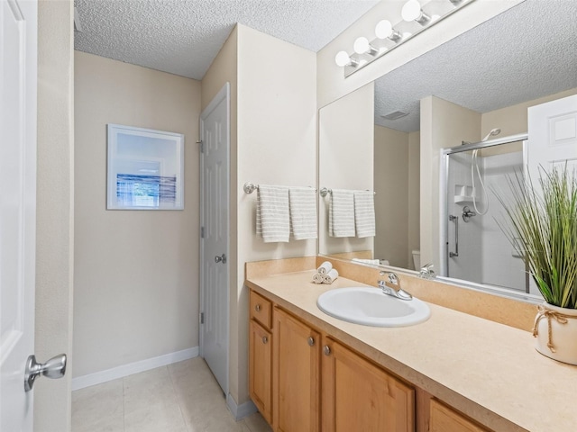 2369 Five Forks Trl, The Villages, FL 32162 - bathroom featuring vanity, a textured ceiling, a shower stall, and tile patterned floors