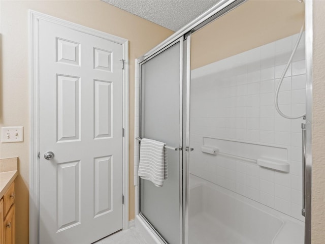 2369 Five Forks Trl, The Villages, FL 32162 - full bathroom featuring an enclosed shower, vanity, and a textured ceiling