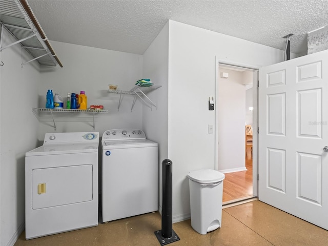 2369 Five Forks Trl, The Villages, FL 32162 - laundry room with independent washer and dryer and a textured ceiling