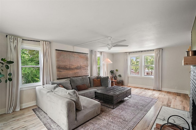 126 E Beach St, Groveland, FL 34736 - living room featuring a ceiling fan, light wood finished floors, and healthy amount of natural light