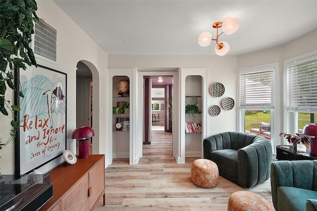 126 E Beach St, Groveland, FL 34736 - living area featuring wood finished floors and arched walkways