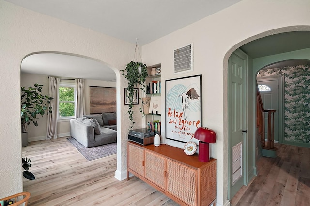 126 E Beach St, Groveland, FL 34736 - corridor featuring wood finished floors, arched walkways, and stairs