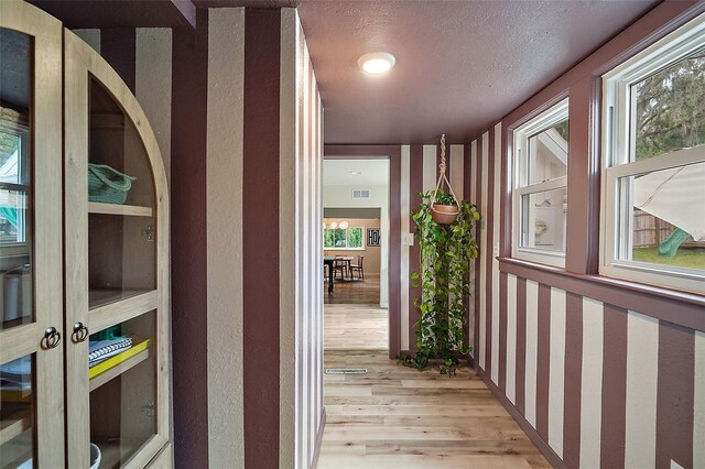 126 E Beach St, Groveland, FL 34736 - hallway featuring light wood finished floors and a textured wall