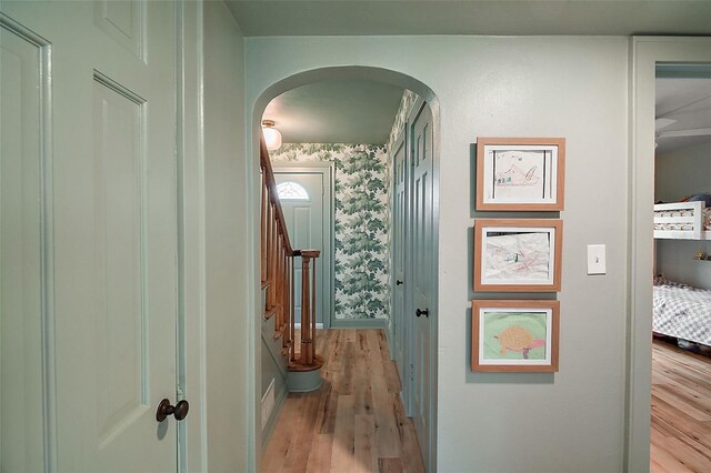 126 E Beach St, Groveland, FL 34736 - corridor with arched walkways, light wood-style floors, and stairs