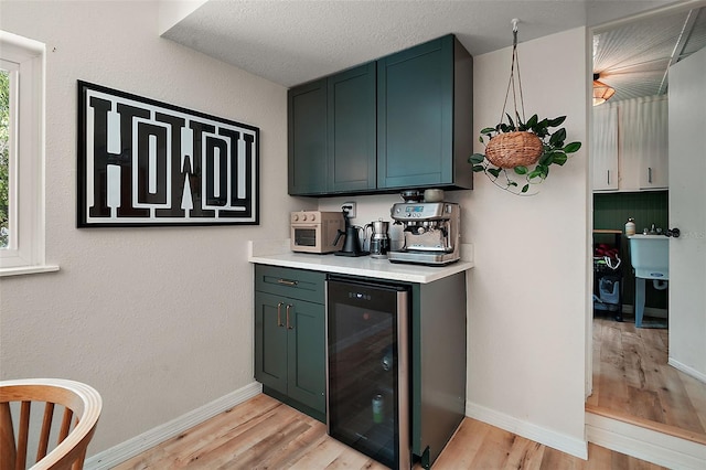 126 E Beach St, Groveland, FL 34736 - bar area featuring beverage cooler and light wood-type flooring