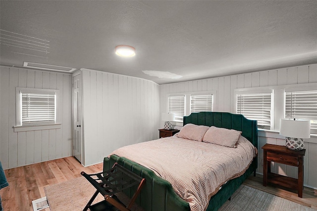 126 E Beach St, Groveland, FL 34736 - bedroom featuring light wood-type flooring and wooden walls
