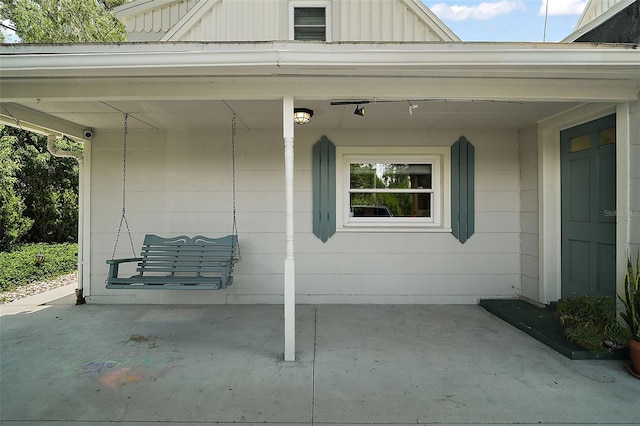 126 E Beach St, Groveland, FL 34736 - doorway to property with board and batten siding and a security system