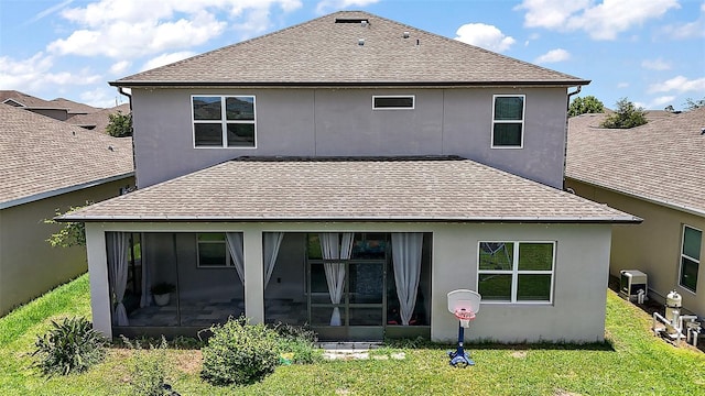 9153 Carmela Ave, Davenport, FL 33897 - rear view of property with roof with shingles, a sunroom, a lawn, and stucco siding