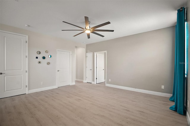 9153 Carmela Ave, Davenport, FL 33897 - unfurnished bedroom with light wood-style floors and a ceiling fan