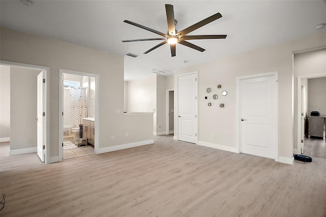 9153 Carmela Ave, Davenport, FL 33897 - unfurnished living room featuring a ceiling fan and light wood-style flooring