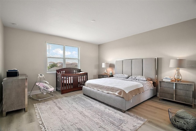 9153 Carmela Ave, Davenport, FL 33897 - bedroom with light wood-type flooring and baseboards