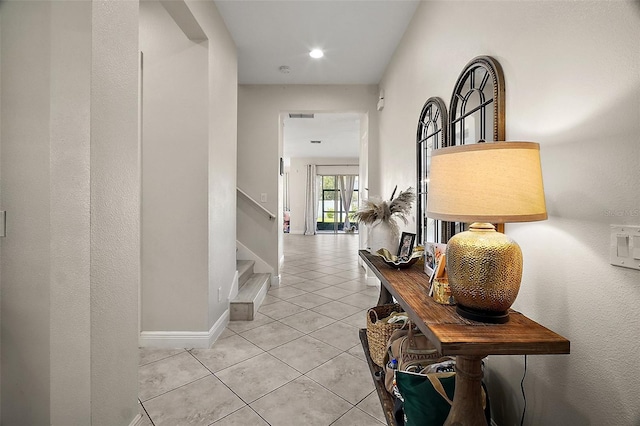 9153 Carmela Ave, Davenport, FL 33897 - hallway with light tile patterned floors, stairs, and recessed lighting