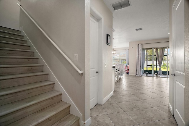 9153 Carmela Ave, Davenport, FL 33897 - stairway with tile patterned flooring and baseboards