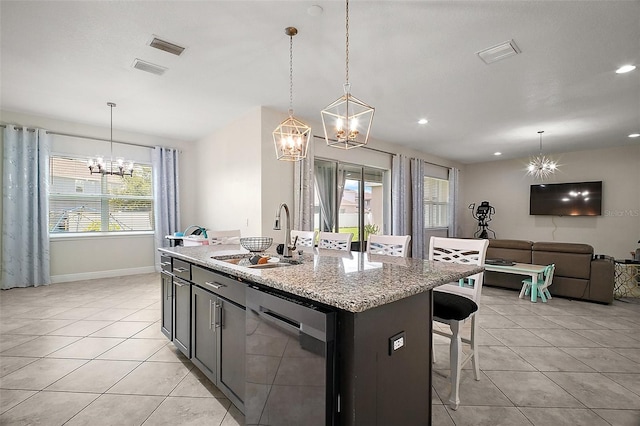 9153 Carmela Ave, Davenport, FL 33897 - kitchen with stainless steel dishwasher, a chandelier, light tile patterned floors, open floor plan, and recessed lighting