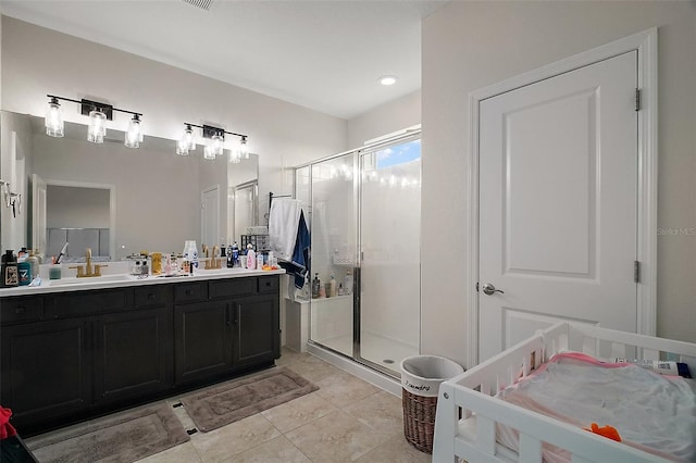 9153 Carmela Ave, Davenport, FL 33897 - bathroom featuring a stall shower, tile patterned flooring, and double vanity