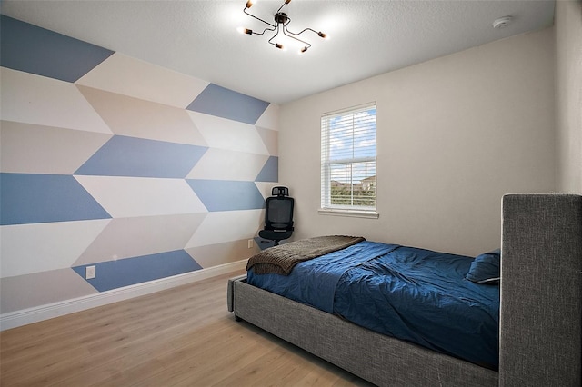 9153 Carmela Ave, Davenport, FL 33897 - bedroom with wood finished floors and a chandelier