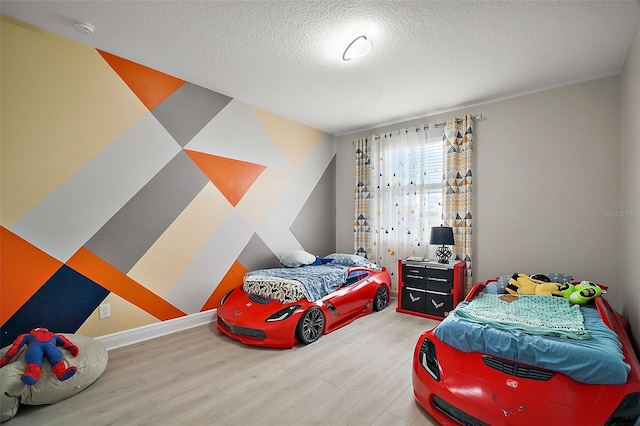 9153 Carmela Ave, Davenport, FL 33897 - bedroom with wood finished floors and a textured ceiling