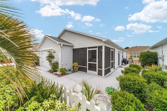 2237 Jetta Way, The Villages, FL 32162 - rear view of house with a sunroom, a fenced backyard, and a patio
