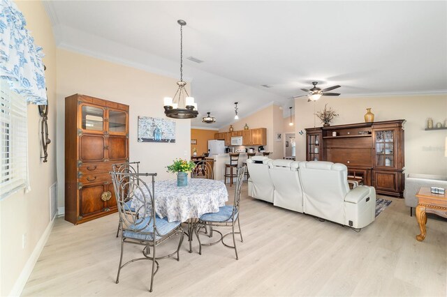 2237 Jetta Way, The Villages, FL 32162 - dining area featuring light wood finished floors, ceiling fan, a chandelier, lofted ceiling, and crown molding