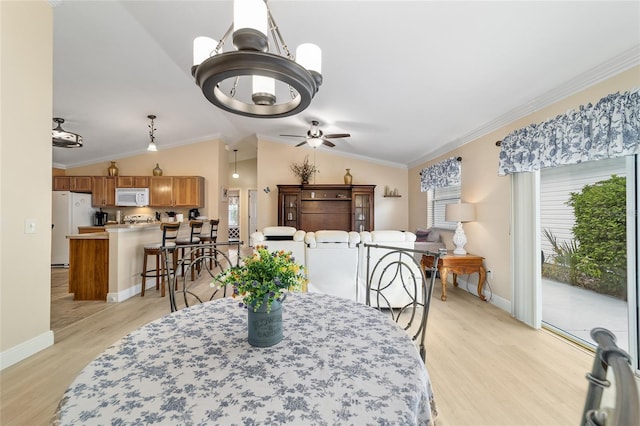 2237 Jetta Way, The Villages, FL 32162 - dining area with light wood-style floors, ceiling fan, crown molding, vaulted ceiling, and a chandelier
