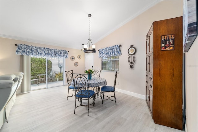 2237 Jetta Way, The Villages, FL 32162 - dining room featuring crown molding, vaulted ceiling, light wood finished floors, and a chandelier
