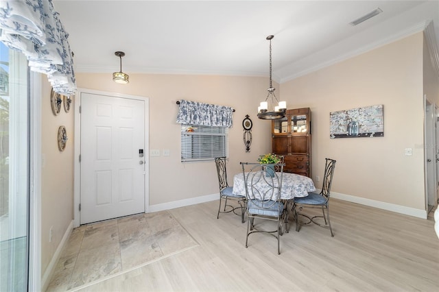 2237 Jetta Way, The Villages, FL 32162 - dining space with a chandelier, ornamental molding, and light wood-type flooring
