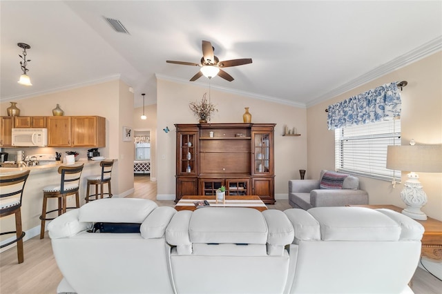 2237 Jetta Way, The Villages, FL 32162 - living area with light wood-style floors, a ceiling fan, healthy amount of natural light, lofted ceiling, and ornamental molding