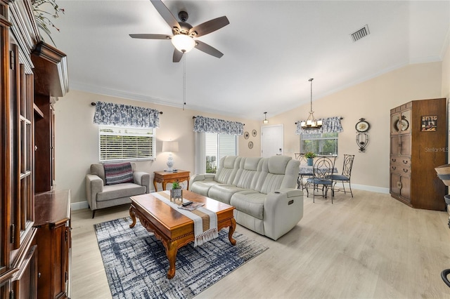 2237 Jetta Way, The Villages, FL 32162 - living area featuring ceiling fan, vaulted ceiling, ornamental molding, light wood-style floors, and a chandelier