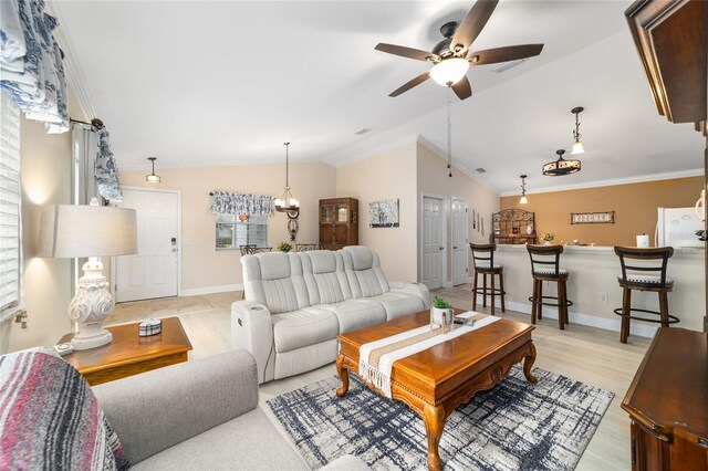 2237 Jetta Way, The Villages, FL 32162 - living area with vaulted ceiling, light wood-type flooring, a ceiling fan, and crown molding