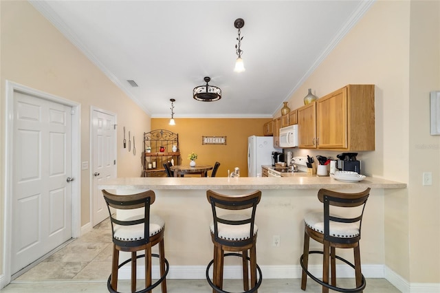 2237 Jetta Way, The Villages, FL 32162 - kitchen with white appliances, ornamental molding, a breakfast bar, light countertops, and a peninsula