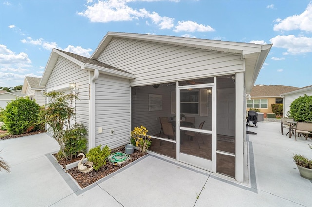 2237 Jetta Way, The Villages, FL 32162 - back of property featuring a sunroom and a patio