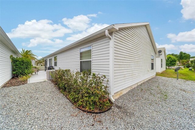 2237 Jetta Way, The Villages, FL 32162 - view of side of home with a patio and a central air condition unit