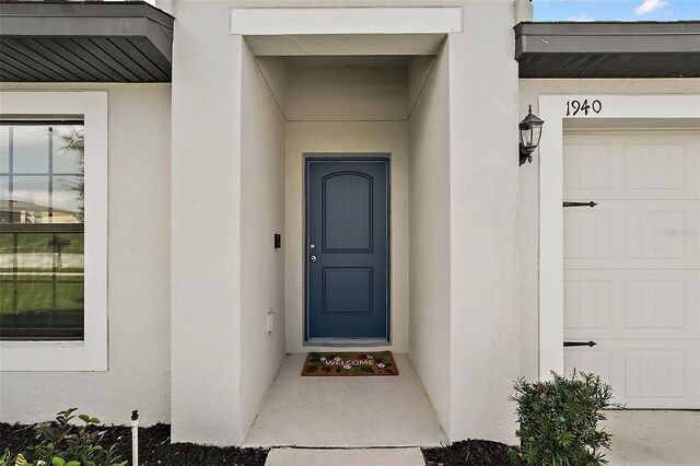 1940 Piedmont Ct, Mascotte, FL 34753 - property entrance with stucco siding
