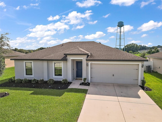 1940 Piedmont Ct, Mascotte, FL 34753 - view of front facade with stucco siding, driveway, a shingled roof, and a garage