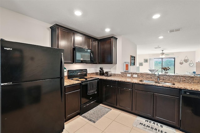 1940 Piedmont Ct, Mascotte, FL 34753 - kitchen featuring black appliances, light stone counters, light tile patterned floors, ceiling fan, and dark brown cabinetry