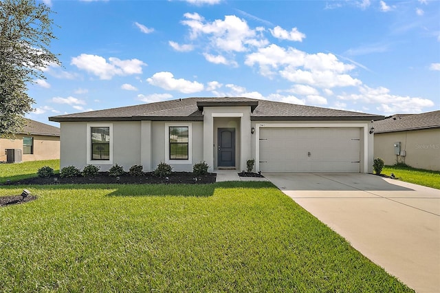 1940 Piedmont Ct, Mascotte, FL 34753 - prairie-style home featuring stucco siding, an attached garage, concrete driveway, a front yard, and a shingled roof
