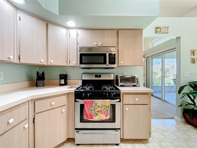 27141 Racquet Cir, Leesburg, FL 34748 - kitchen featuring appliances with stainless steel finishes, light countertops, and light brown cabinetry