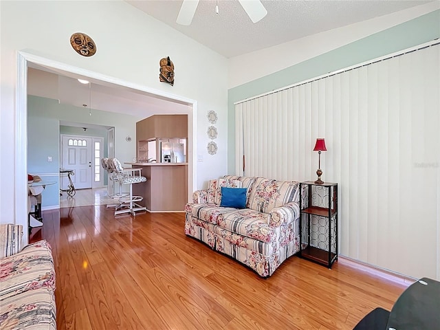 27141 Racquet Cir, Leesburg, FL 34748 - living room with light wood-style floors, ceiling fan, and lofted ceiling