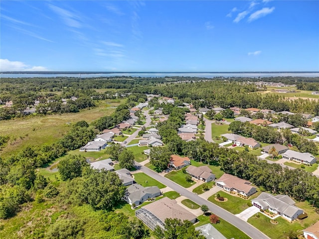 27141 Racquet Cir, Leesburg, FL 34748 - aerial perspective of suburban area with a nearby body of water and a forest