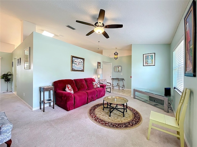 27141 Racquet Cir, Leesburg, FL 34748 - living area featuring light carpet, a ceiling fan, and a textured ceiling