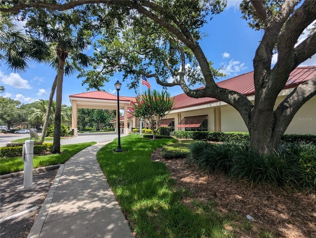 27141 Racquet Cir, Leesburg, FL 34748 - view of property exterior with a metal roof and stucco siding