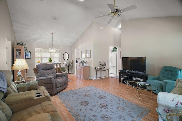 1007 Diego Ct, The Villages, FL 32159 - living room with a ceiling fan, a chandelier, light wood-type flooring, and high vaulted ceiling