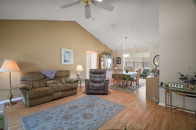 1007 Diego Ct, The Villages, FL 32159 - living area with ceiling fan, a chandelier, light wood finished floors, high vaulted ceiling, and arched walkways