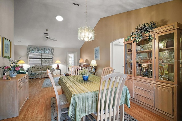 1007 Diego Ct, The Villages, FL 32159 - dining space with lofted ceiling, a ceiling fan, light wood-type flooring, a chandelier, and arched walkways